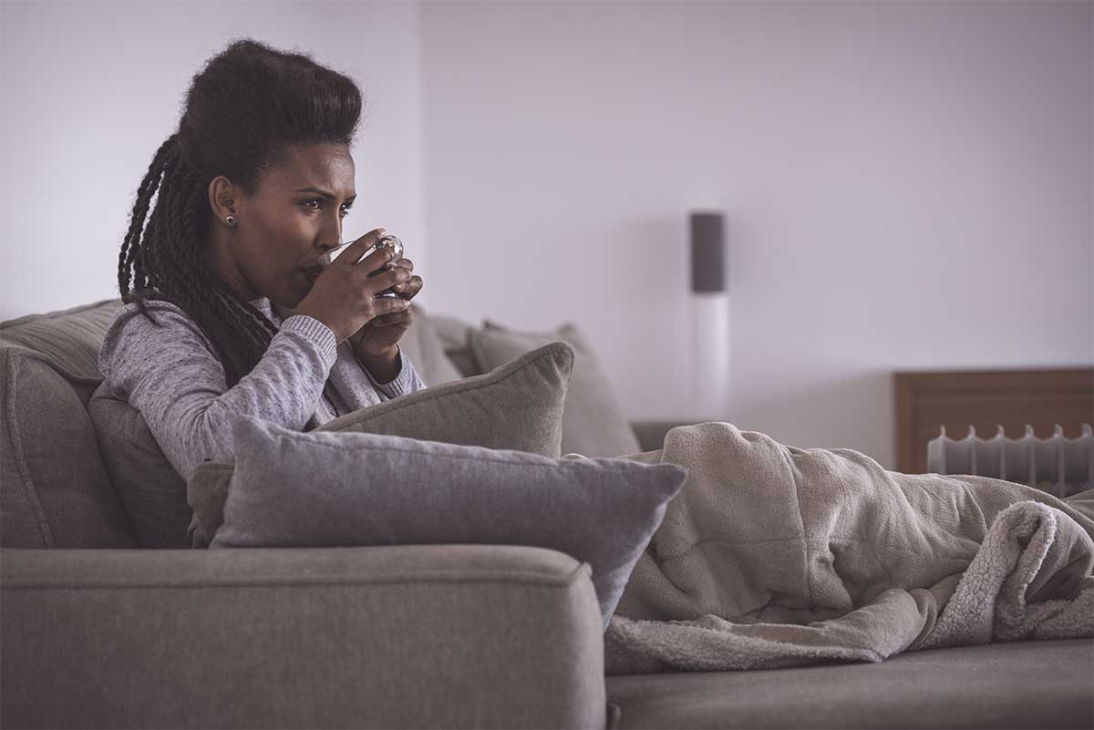 Woman Drinking Coffee On Couch